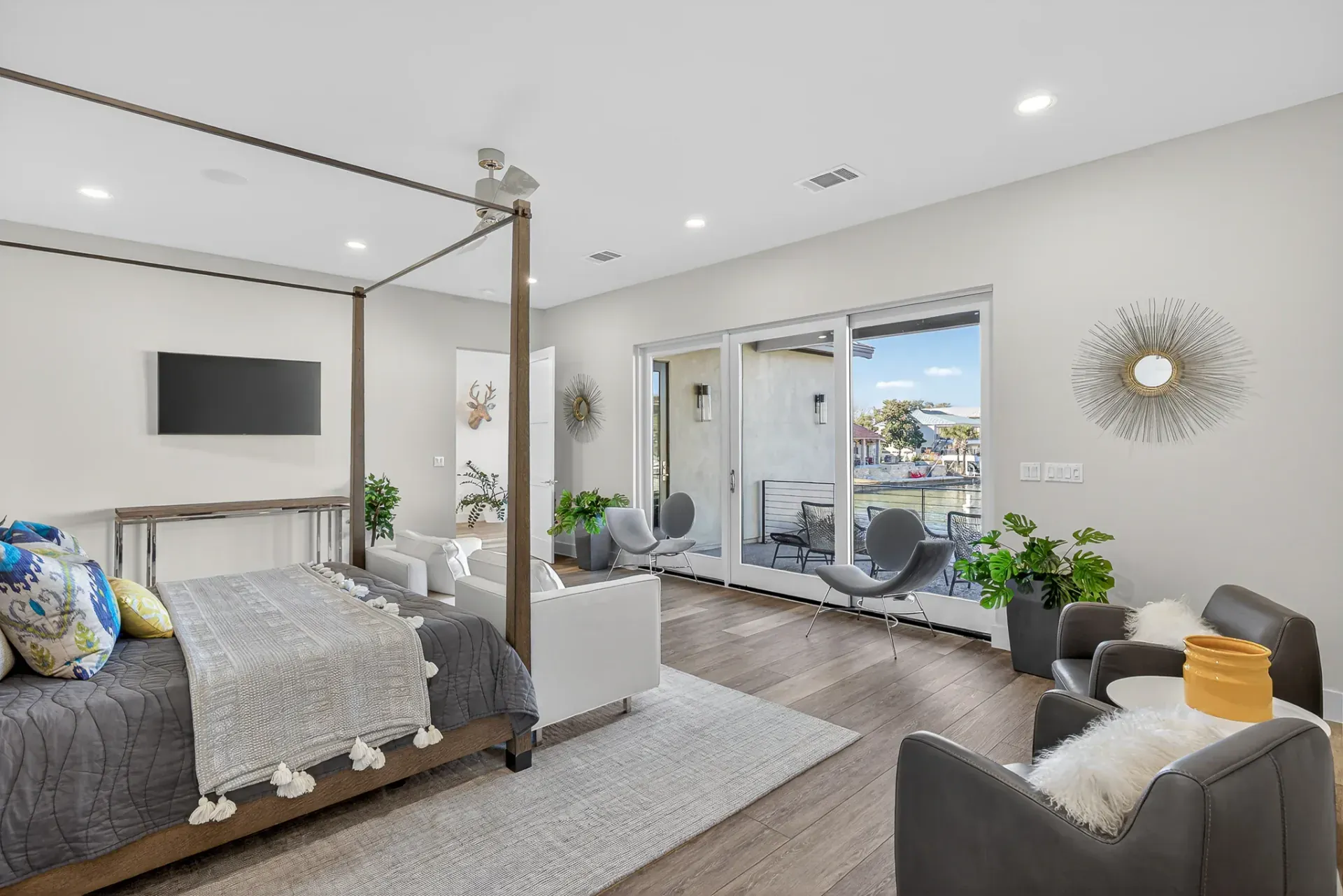 Master suite with canopy bed and waterfront views